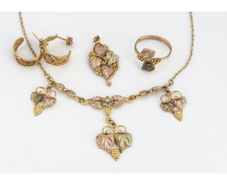 An American 10k three colour gold necklace by Black Hills gold, comprising necklace, ring, earrings, and pendant, marked to r