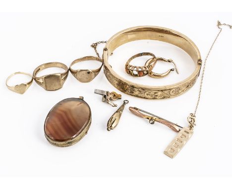 A quantity of 9ct gold, including a hinged bangle, two signet rings, another coral example, gold ingot pendant, heart shaped 