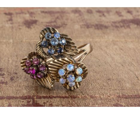 A yellow metal dress ring of leaf design, claw set with clusters of rubies, sapphires and opals, ring size L, 4.1g 