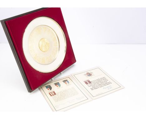 A 1970s silver Queen Elizabeth II commemorative The College of Arms plate, 27cm diameter and 18.4 ozt, in presentation box wi