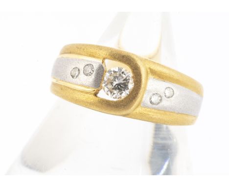 A continental two colour gold diamond dress ring,  brilliant cut, in a textured matt buckle setting, inner shank marked 750, 