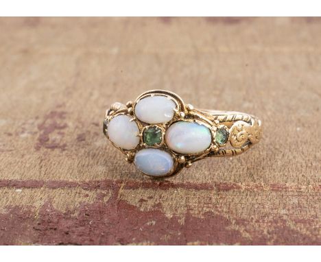 A 19th century emerald, opal and paste posy ring, the quatrefoil setting, having scroll engraved shoulders, ring size K, 2.1g