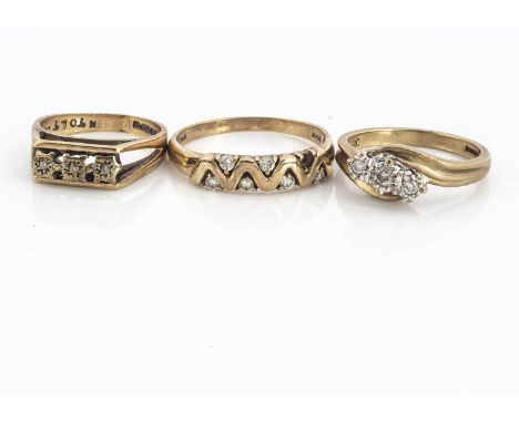 Three 9ct gold diamond rings, comprising an illusion set three stone cross over ring size L1/2, another three stone I and a d