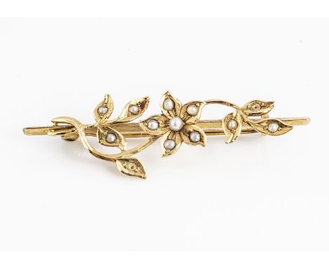 An Edwardian seed pearl 15ct gold brooch, of flower design, centred with a flower surrounded by leaves, marked 15ct to revers