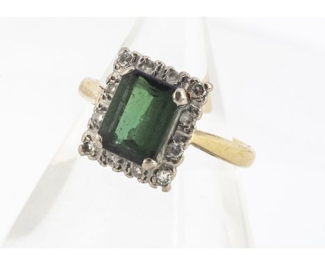 An 18ct gold green tourmaline and diamond cluster ring,  the mixed rectangular cut green tourmaline in a claw setting, surrou