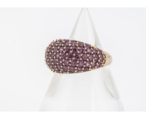 An 18ct gold ruby bombe shaped dress ring, the mixed round cut rubies in claw settings, in yellow 18ct gold, ring size N, 7.5