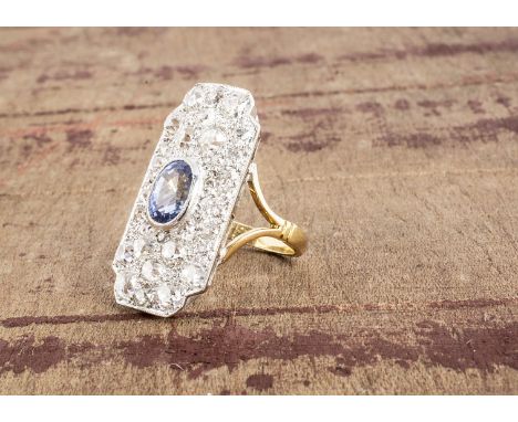 An Art Deco sapphire and diamond tablet cluster ring, the oval mixed cut sapphire surrounded by a rectangular tablet of diamo