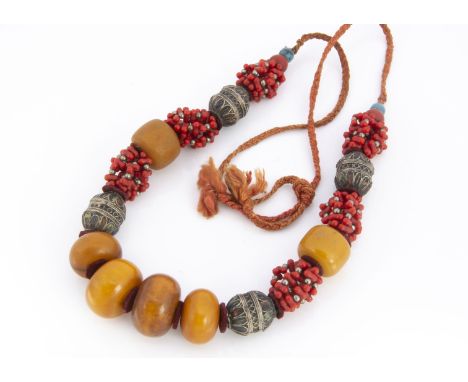 A Moroccan pressed amber, white metal, coral and enamel necklace, in the Berber style, 52 cm 250g