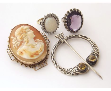 A 9ct gold cameo brooch, two dress rings (one stamped 925) a silver Celtic brooch We are unable to provide condition reports 