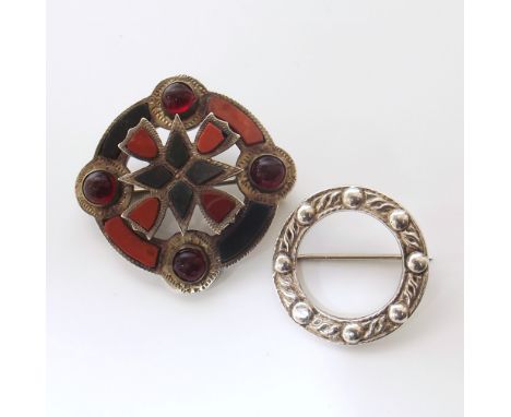 A Scottish hardstone brooch and Scottish celtic brooch (silver) We are unable to provide condition reports for this sale.