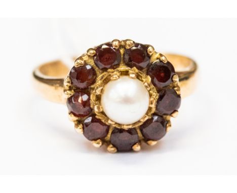 A 9ct gold, cultured pearl and garnet cluster dress ring, comprising a central pearl with a garnet surround, size O, with a t