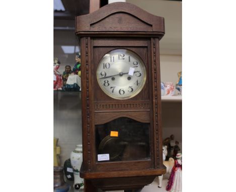 An oak cased wall clock with Arabic numerals to dial; together with an oak cased mantle clock (2) 