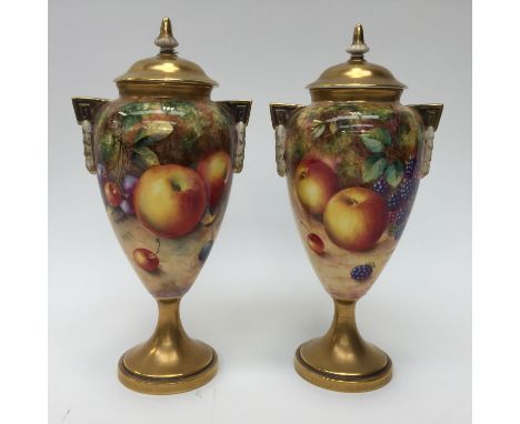  A pair of Royal Worcester fruit painted pedestal vases and covers, both signed Freeman, ref: 2713 