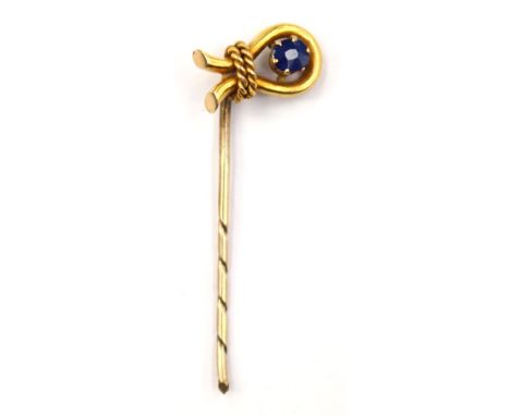A 15ct gold and sapphire stick pin, with a omega shape with rope detail,  set to the centre with a claw set sapphire, total g