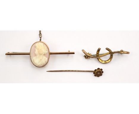 A 9ct gold stick pin, set with diamond chip, a horseshoe bar brooch, and a yellow metal bar brooch set with a cameo (3)