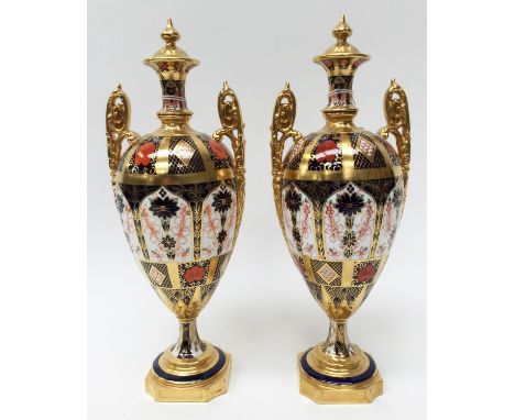 A pair of Royal CrowN Derby Imari 1128 pattern twin handled urn vases, both first quality 