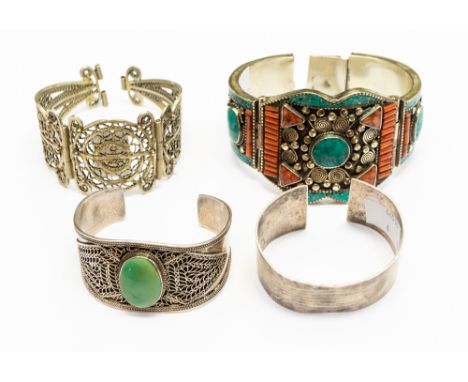 A collection of silver and white metal bangles, some possibly Chinese or Tibetan, to include a sterling silver bangle with fi