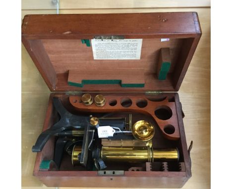 A Swift and Son brass and lacquered monocular microscope, first half of the 20th Century, in a fitted mahogany case