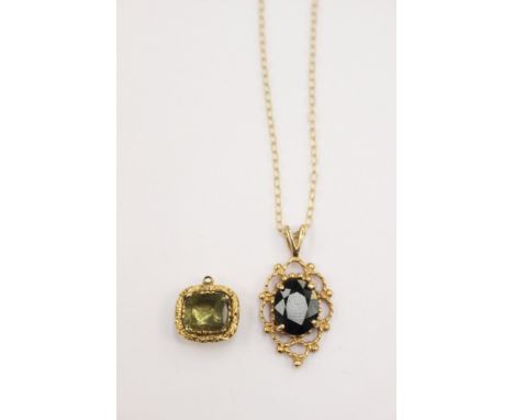 A 9ct gold sapphire pendant, comprising an oval claw set sapphire with ornate surround, on a fine yellow metal chain; togethe