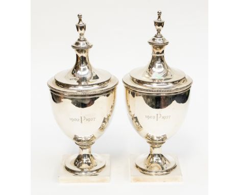  A pair of Tiffany silver Richardson Urn vases, Neoclassical pedestal form, on square bases, beaded borders and urn finials, 