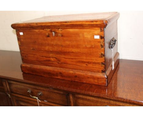 A 19th Century pine trunk, plank form, fitted with carrying handles