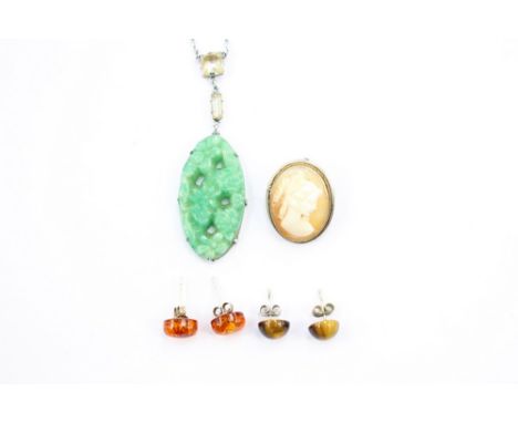 An Art Deco Jade style glass pendant, a pair of Tigers Eye earrings, a pair of amber earrings and a continental silver .800 c