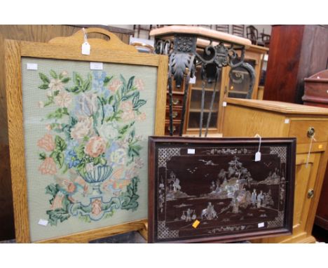 A hardwood tray inlaid with mother of pearl in an oriental design, together with an oak framed firescreen with woolwork panel