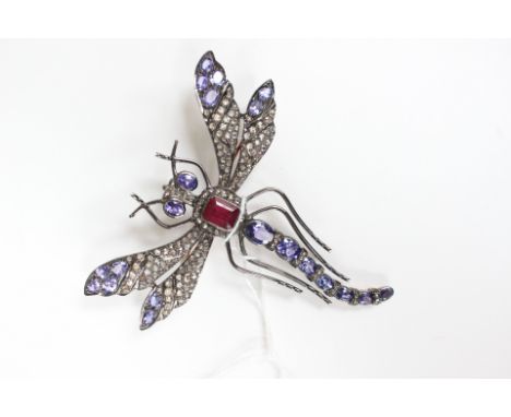A diamond, ruby and tanzanite brooch, in the form of a dragonfly, Victorian style, the wings set with rose cut diamonds and o