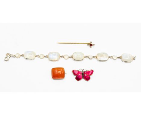  A carnelian and yellow metal brooch; together with a stick pin with garnet and seed pearls, a moonstone and silver bracelet 