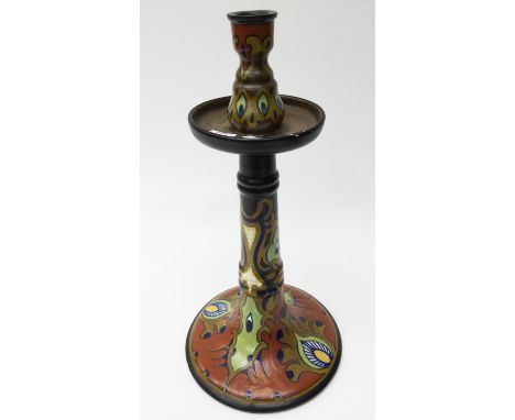 A Gouda Rhodian candlestick, measuring approx 39.5 cm high, Peacock feathers hand painted on terracotta ground 