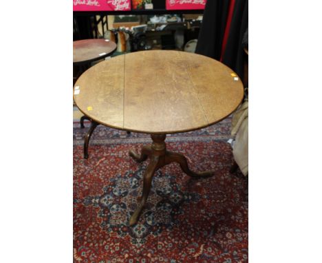 A George III oak tilt top tripod table, 70cm high, 80cm in diameter