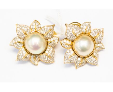 A pair of pearl and diamond cluster 18ct gold flower head earrings, of dual purpose having removable large semi-spherical cul