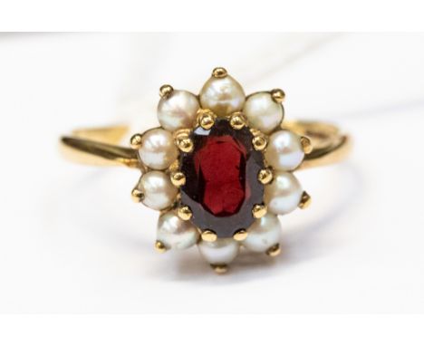A 9ct gold, pearl and garnet cluster ring, central oval garnet with a pearl surround, size Q1/2, total gross weight approx 3g