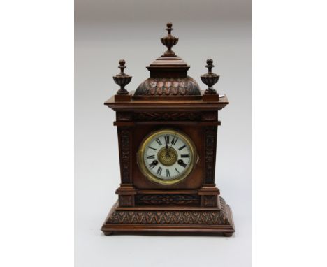 A late 19th Century oak case and mantel clock
