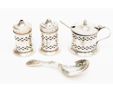 A three piece cruet set with blue glass liners, a caddy spoon and a mustard spoon, cruet, Birmingham 1934, caddy spoon, Sheff