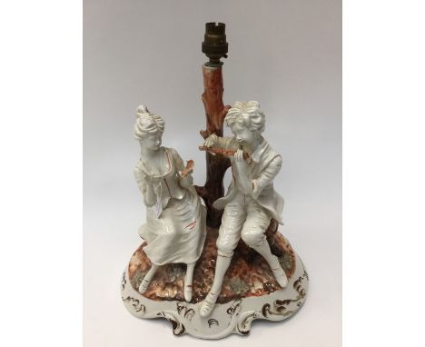 An Italian lamp base with male and female musicians/vocalist 'Bossami' signed to base a/f