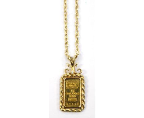 A pendant comprising a one gram of fine gold ingot, set in a 14ct gold surround, on a 9ct gold chain, length of chain approx 
