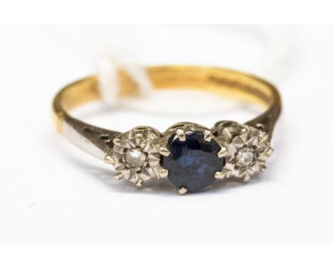 An 18ct gold ring with platinum, comprising a central set round sapphire flanked by two illusion set diamonds either side, si