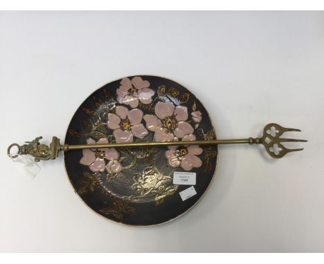  A Cornish Art plate, Marazion, with apple blossom design, together with a brass toasting fork 'Cat & Fiddle' (2) 