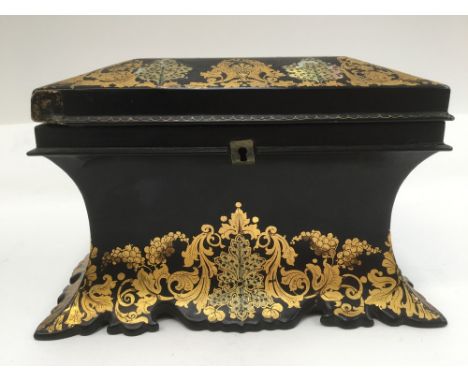 A mid 19th century black lacquered papier mache tea caddy, circa 1860, of waisted form, the top and sides gilded throughout w