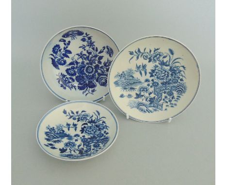 Three Worcester Blue and White Saucers. Two decorated with 'The Fence' pattern The other decorated with Floral sprays & Butte