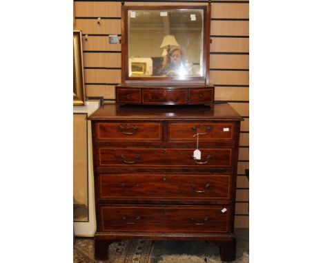 A George III mahogany chest of drawers, fitted with two short over three long graduated drawers, raised on bracket feet, toge