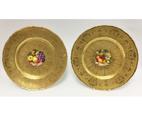 A pair of Royal Worcester footed gilt edged fruit painted cabinet plates, both signed, one by H. Henry, one by Gates (2) 