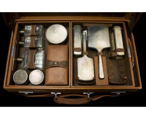  A George VI Mappin & Webb tan leather dressing case, fully fitted interior with silver mounted brushes and cosmetic jars wit