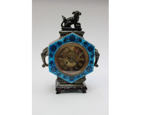 Majolica Continental mantle clock with brass dial and Roman numerals, Dog of Foe finial and Elephant head handles to sides 