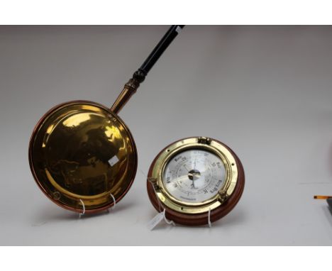 A circular, port hole style barometer, together with a copper and brass warming pan (2)