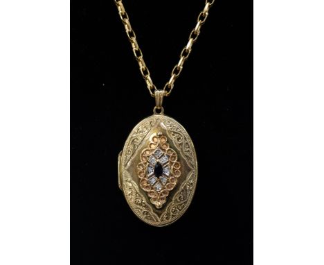 A yellow metal locket set with a marquise sapphire, with a surround of small diamonds, locket size approx 35mm x 25mm, on a 9