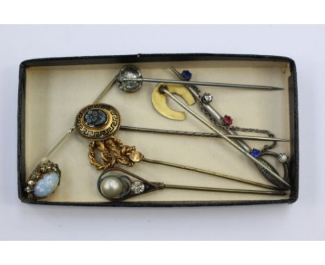 A Victorian mourning stick pin with flower head cameo centre, key fret enamelled border, engraved to reverse for 1870, a gold