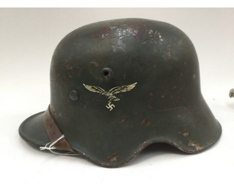Reproduction WW1 M18 cut out German steel helmet with Third Reich Luftwaffe insignia. Complete with liner and chinstrap.