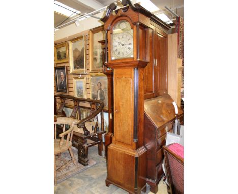 A George III oak 30 hour longcase clock, the dial inscribed 'Jonathan Graham', the hood with a swan neck pediment, the single